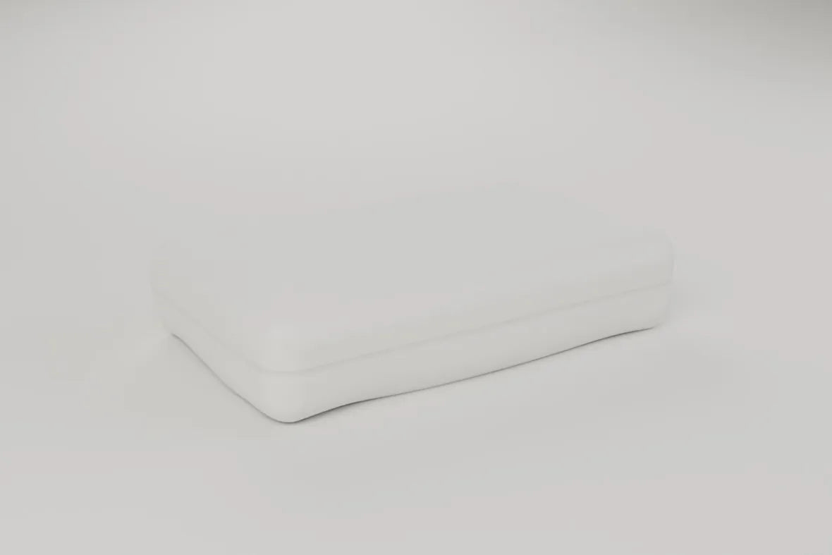The foam pillow on a pale studio ground. Rendering, not a photograph of shipped goods.