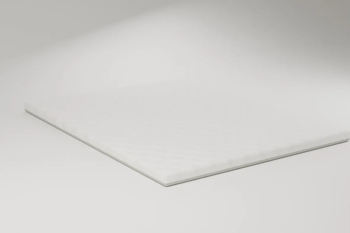 The topper lying flat with its quilted surface facing up, on a pale studio ground. Rendering, not a photograph of shipped goods.